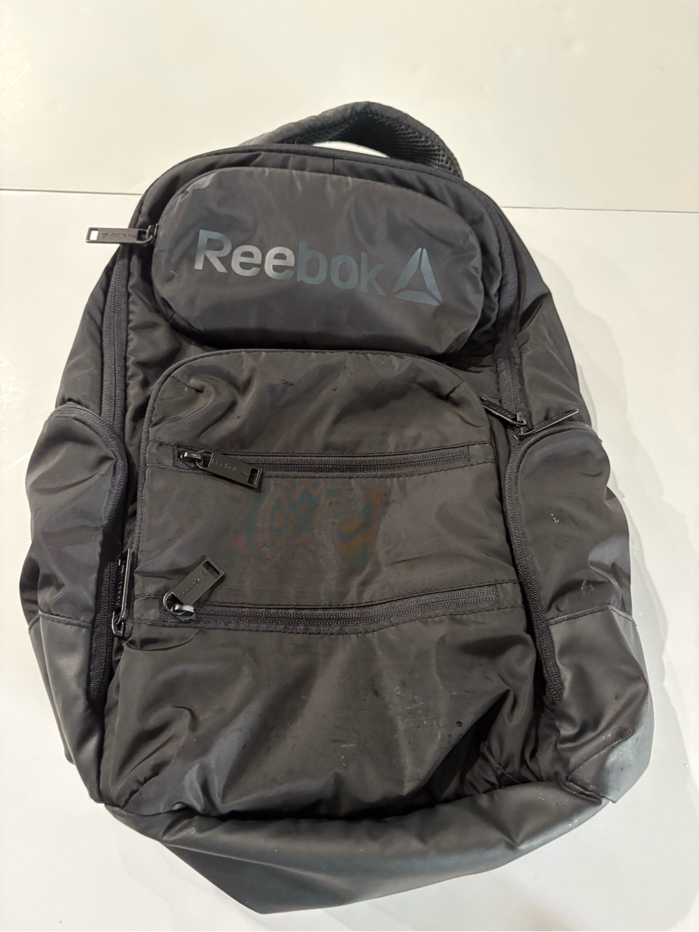 Reebok Black Backpack with button laptop sleeve and lots of zippered pockets